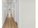 Bright hallway with wood-look floors leads to rooms with white doors and ample natural light at 4234 4Th S St, St Petersburg, FL 33705