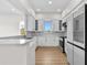 Modern kitchen with white cabinetry, stainless steel appliances, quartz countertops, and modern finishes at 4234 4Th S St, St Petersburg, FL 33705