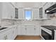 Stylish kitchen featuring quartz countertops, stainless steel appliances, and sleek white cabinetry at 4234 4Th S St, St Petersburg, FL 33705