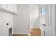 Clean and functional laundry room with white cabinetry, sink, and wood-look flooring at 4234 4Th S St, St Petersburg, FL 33705