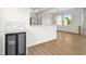 Open floor plan with wood-look floors, bar area, modern lighting, and natural light at 4234 4Th S St, St Petersburg, FL 33705