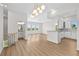 Spacious living area with hardwood floors, modern lighting, and an open concept to kitchen at 4234 4Th S St, St Petersburg, FL 33705