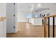 Open-concept living area with hardwood floors, modern lighting, fresh paint, and open to kitchen with bar seating at 4234 4Th S St, St Petersburg, FL 33705