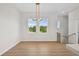 Bright, airy living room showcasing hardwood floors, large windows, and modern chandelier lighting at 4234 4Th S St, St Petersburg, FL 33705