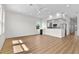 Open-concept living room featuring wood-look flooring, bright natural light and a modern ceiling fan at 4234 4Th S St, St Petersburg, FL 33705