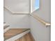 Elegant staircase featuring hardwood steps, a white painted base, and a modern wooden handrail at 4234 4Th S St, St Petersburg, FL 33705