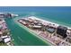 Expansive aerial view showcasing the coastal community, beachfront, and turquoise water at 7532 Bayshore Dr # 205, Treasure Island, FL 33706