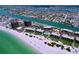 Gorgeous aerial view of beachfront properties, beach access, and sparkling waterways at 7532 Bayshore Dr # 205, Treasure Island, FL 33706