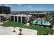 Beautiful aerial view of the condos, pool, and lush landscaping in a waterfront community at 7532 Bayshore Dr # 205, Treasure Island, FL 33706
