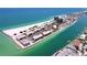 Stunning aerial view of a beachfront community with turquoise waters and white sand beaches at 7532 Bayshore Dr # 205, Treasure Island, FL 33706