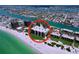 Stunning aerial view of beachfront condos overlooking green lawns and crystal clear water at 7532 Bayshore Dr # 205, Treasure Island, FL 33706