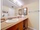 Bright bathroom features a vanity with an oversized mirror and updated lighting at 7532 Bayshore Dr # 205, Treasure Island, FL 33706