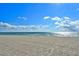Beautiful sandy beach with clear blue skies and calm ocean waters at 7532 Bayshore Dr # 205, Treasure Island, FL 33706