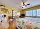 Bright bedroom featuring tile floors, mirrored closet doors, TV, ceiling fan and decorative bedspread at 7532 Bayshore Dr # 205, Treasure Island, FL 33706