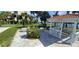 Charming community space with seating, a gazebo, and lush landscaping near the water at 7532 Bayshore Dr # 205, Treasure Island, FL 33706
