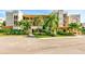 Two-story condo building with lush landscaping and ample parking at 7532 Bayshore Dr # 205, Treasure Island, FL 33706