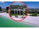 Beautiful beachfront condo building featuring private beach access and lush landscaping with palm trees at 7532 Bayshore Dr # 205, Treasure Island, FL 33706