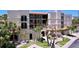 Elegant condominium complex with private balconies and lush tropical landscaping at 7532 Bayshore Dr # 205, Treasure Island, FL 33706