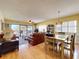 Inviting living room with hardwood floors, dining area, and sliding glass doors to a private balcony at 7532 Bayshore Dr # 205, Treasure Island, FL 33706
