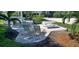 Serene patio area with comfortable lounge chairs and a shaded pergola, perfect for relaxing outdoors at 7532 Bayshore Dr # 205, Treasure Island, FL 33706