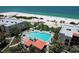 Lovely aerial view of a condo swimming pool close to the beach at 7532 Bayshore Dr # 205, Treasure Island, FL 33706