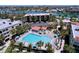 Luxurious swimming pool and jacuzzi at condo complex with lush tropical landscaping at 7532 Bayshore Dr # 205, Treasure Island, FL 33706