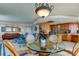 Open dining area with kitchen, living room, and balcony access at 3820 Gulf Blvd # 608, St Pete Beach, FL 33706