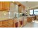 Kitchen boasts granite countertops, wood cabinets, and modern appliances at 3820 Gulf Blvd # 608, St Pete Beach, FL 33706