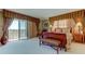 Main bedroom with a king-size bed, stylish furnishings, and access to a balcony at 3820 Gulf Blvd # 608, St Pete Beach, FL 33706