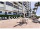 Relaxing patio with tables and chairs near the building at 3820 Gulf Blvd # 608, St Pete Beach, FL 33706
