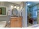Well-appointed bathroom featuring wood cabinets, granite countertops, and a tiled shower at 3820 Gulf Blvd # 608, St Pete Beach, FL 33706