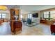 Open living room featuring hardwood floors, comfortable seating, and a large TV at 3820 Gulf Blvd # 608, St Pete Beach, FL 33706