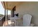 Spacious balcony with white chairs and a table, offering city views at 3820 Gulf Blvd # 608, St Pete Beach, FL 33706