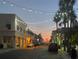 Evening street scene with string lights, palm trees, and pedestrians at 3820 Gulf Blvd # 608, St Pete Beach, FL 33706
