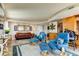 Relaxing living room with leather sofa, blue armchairs, and a view at 3820 Gulf Blvd # 608, St Pete Beach, FL 33706