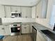 Modern kitchen with grey cabinets, granite countertops, and stainless steel appliances at 1919 21St S St, St Petersburg, FL 33712