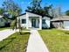 Modern house with white exterior, black accents, and a landscaped lawn at 1919 21St S St, St Petersburg, FL 33712
