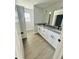 Bathroom with double vanity and gray laminate flooring at 1919 21St S St, St Petersburg, FL 33712