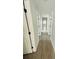 Long hallway with light walls, white trim and wood-look flooring at 1919 21St S St, St Petersburg, FL 33712