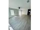 Spacious living area with grey wood-look flooring and a ceiling fan at 1919 21St S St, St Petersburg, FL 33712
