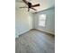 Well-lit bedroom with ceiling fan, closet, and grey flooring at 1919 21St S St, St Petersburg, FL 33712