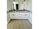 Double vanity bathroom with granite countertop and modern fixtures at 1919 21St S St, St Petersburg, FL 33712
