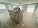 Kitchen island with grey cabinets and a light gray countertop at 1919 21St S St, St Petersburg, FL 33712