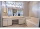 Bathroom with double vanity and striped wallpaper at 14088 Bruni Dr, Spring Hill, FL 34609