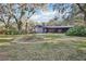 View of the back of the house showcasing the yard and landscaping at 2504 High Oaks Ln, Lutz, FL 33559