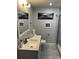 Bright bathroom featuring a modern vanity, decorative artwork, and a glass-enclosed shower with stylish tile work at 4438 58Th N Ave, St Petersburg, FL 33714