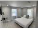 Bright bedroom with neutral walls, two windows with curtains, and a neatly made bed with white linens at 4438 58Th N Ave, St Petersburg, FL 33714