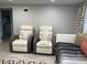 Inviting bedroom featuring theater chairs, enhancing the relaxation space with comfort and modern design elements at 4438 58Th N Ave, St Petersburg, FL 33714