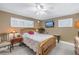 Bright bedroom with a queen-size bed and ceiling fan at 800 Madonna Blvd # B, Tierra Verde, FL 33715