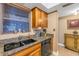 Kitchen boasts a double sink, granite counters, and wood cabinets at 800 Madonna Blvd # B, Tierra Verde, FL 33715